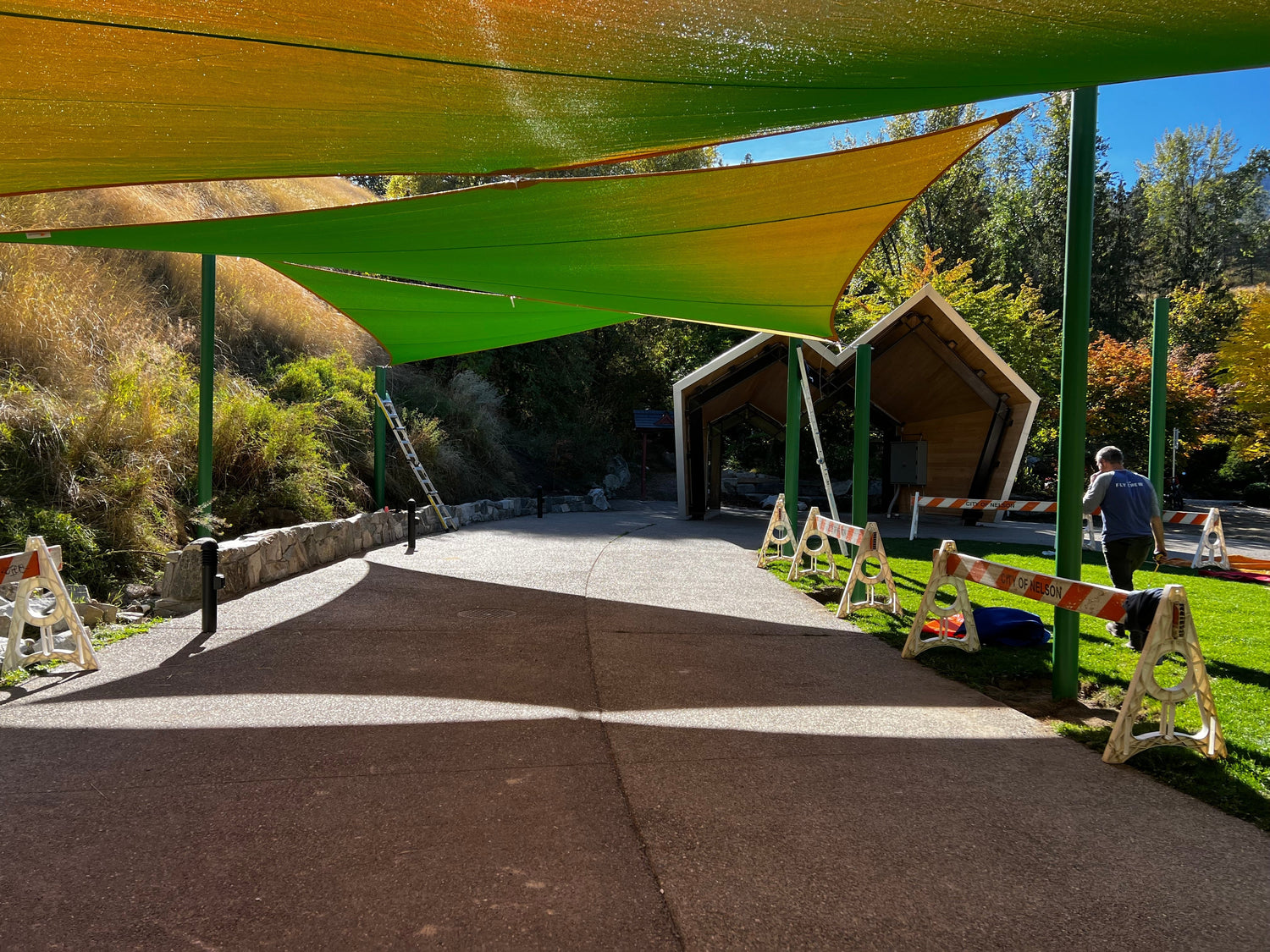walkway with shade sails above it. Greenhouse Shade Cloth.