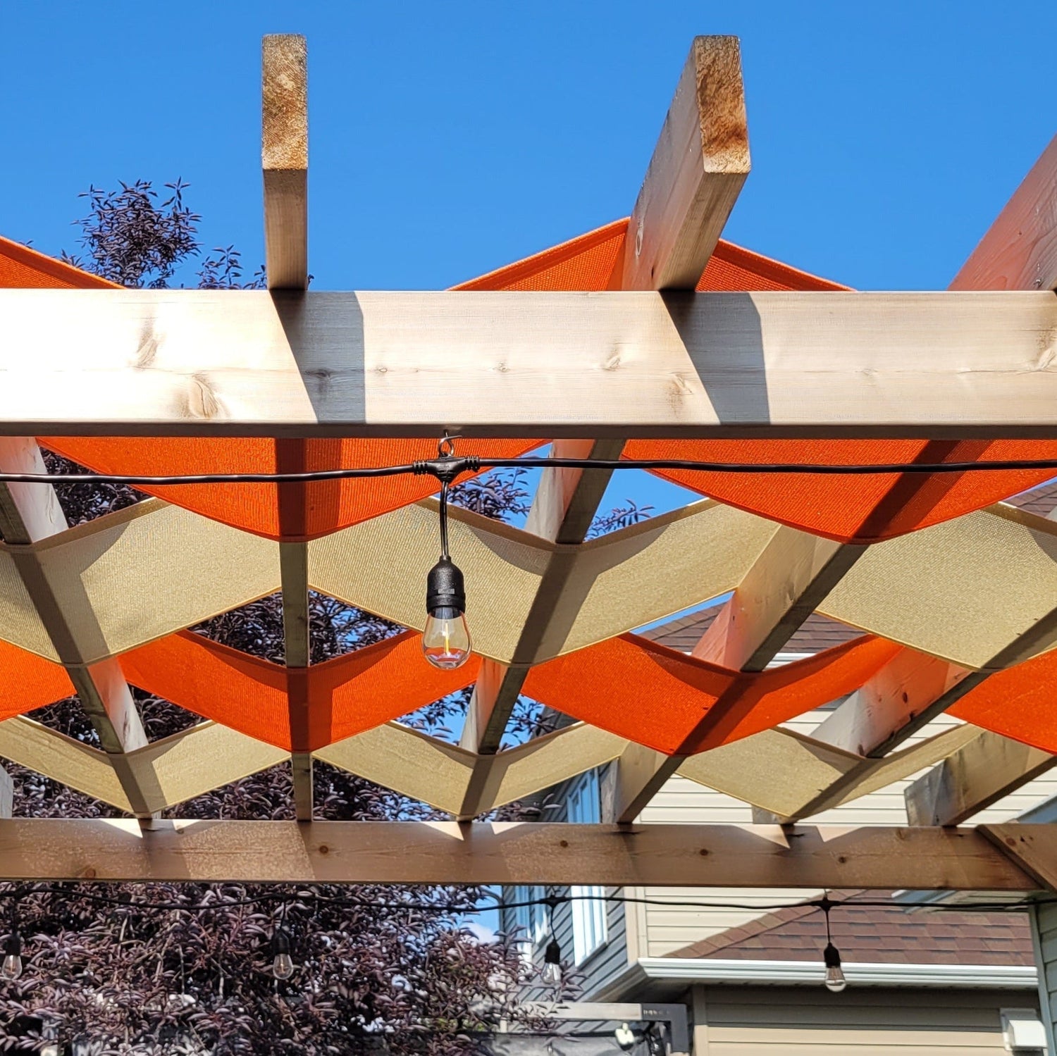 orange and beige pergola shade showcasing creative shade solutions.