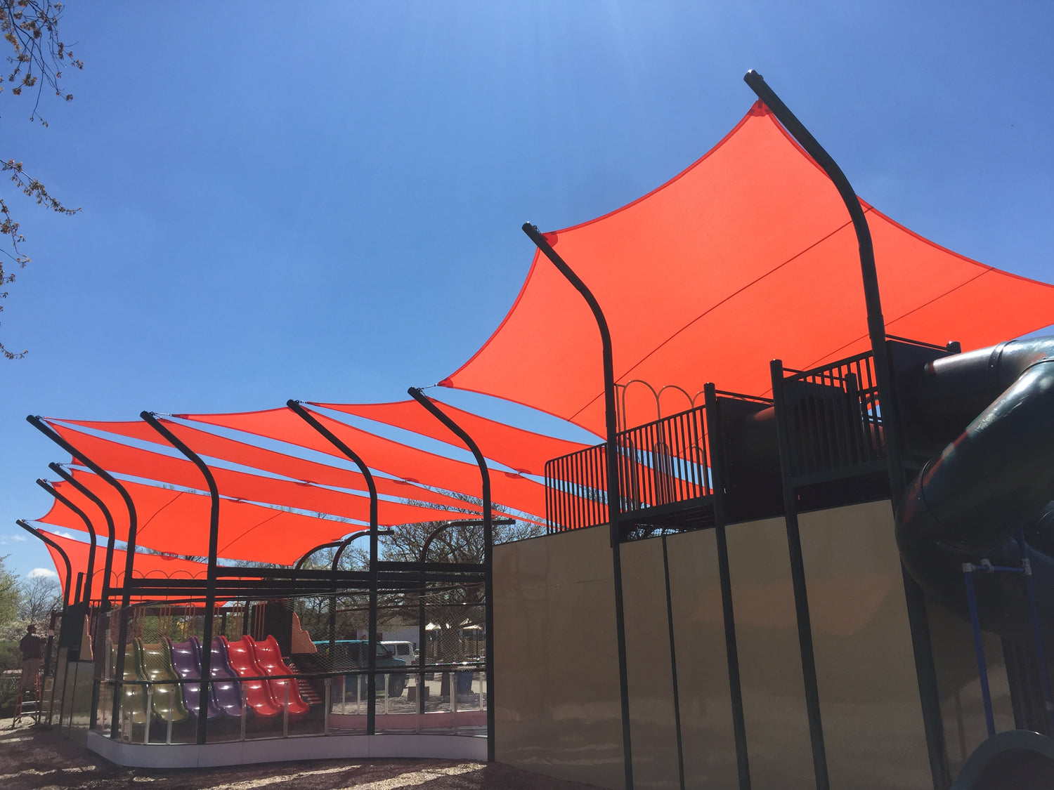 image of orange shade sails representing wind resistance.