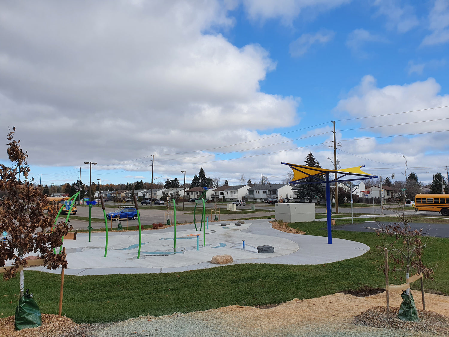 image of a yellow sun shade sail covering part of a playground