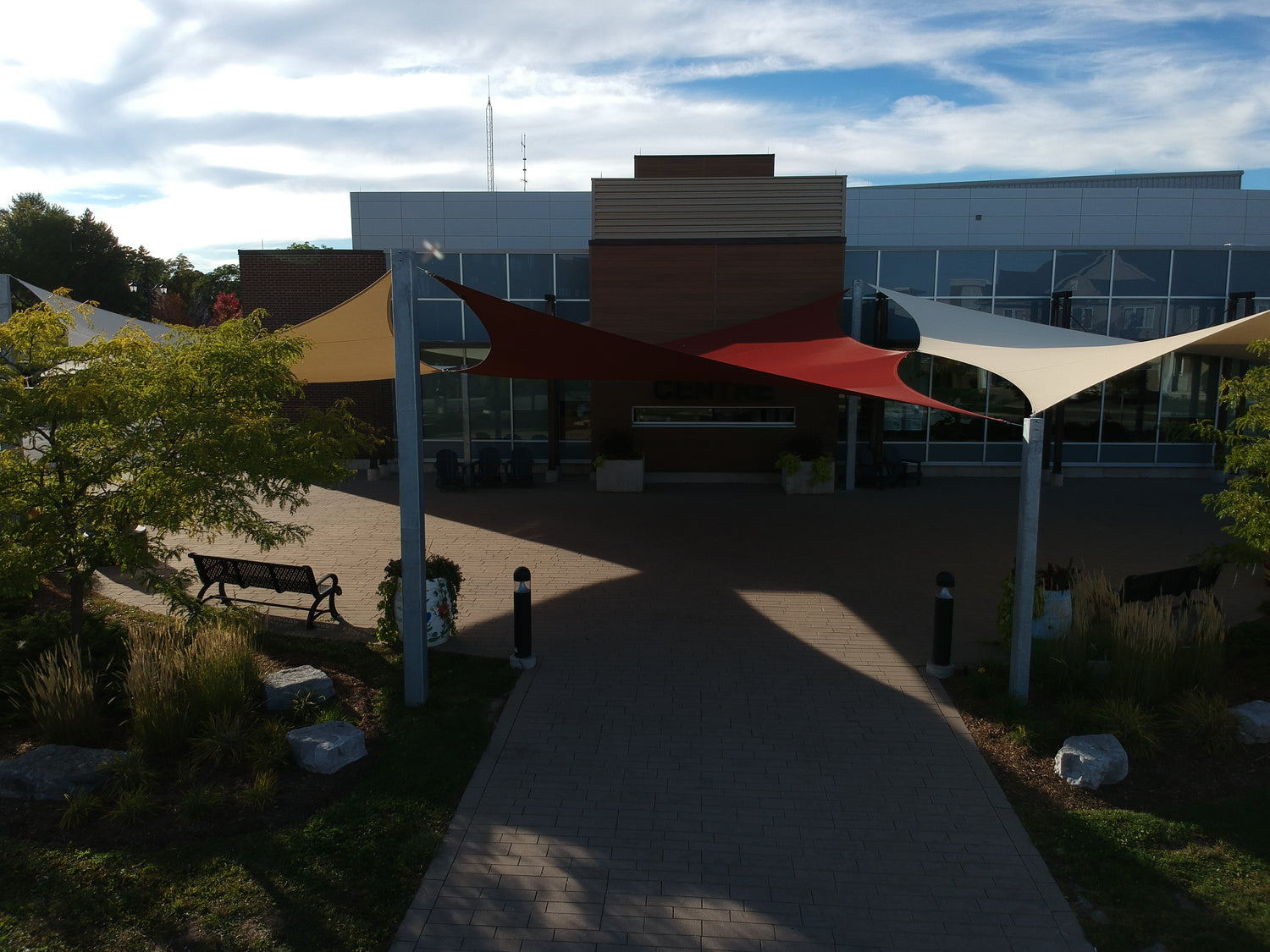 image of sun shade sails covering a entry way to a large building.