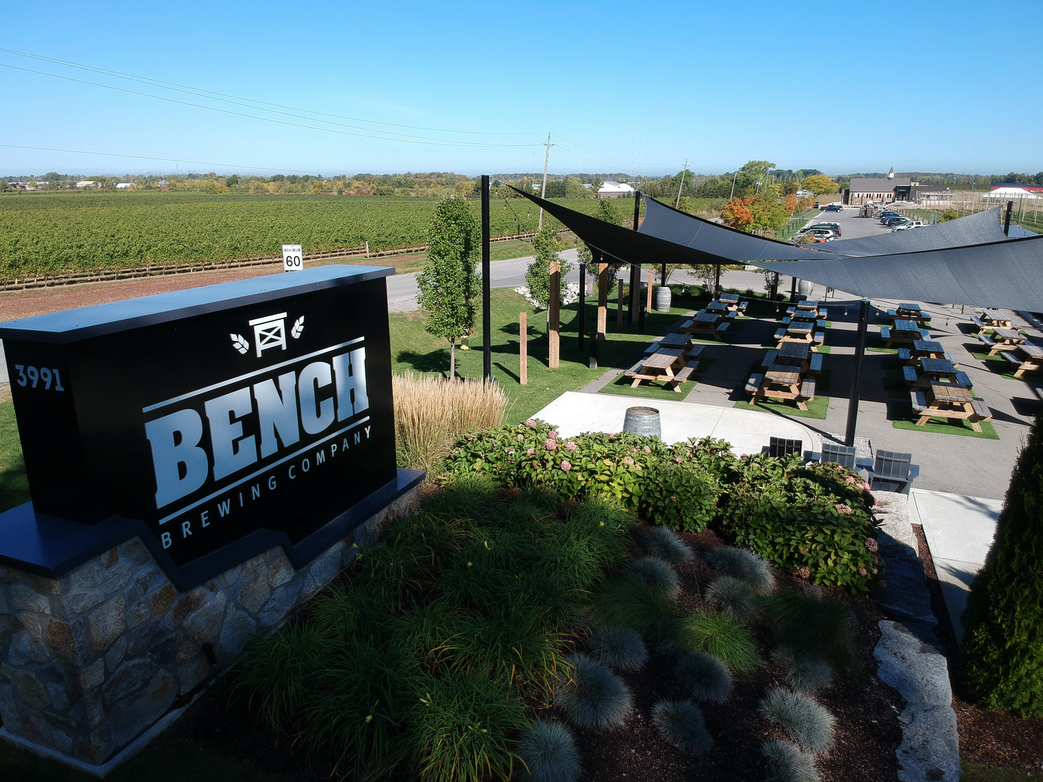 image of the outside of a brewing company with shade sails for patios.