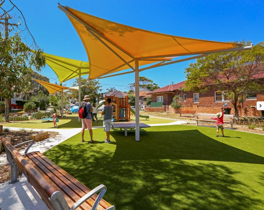 three hypod shade sails at a public park showcasing brand visibility.