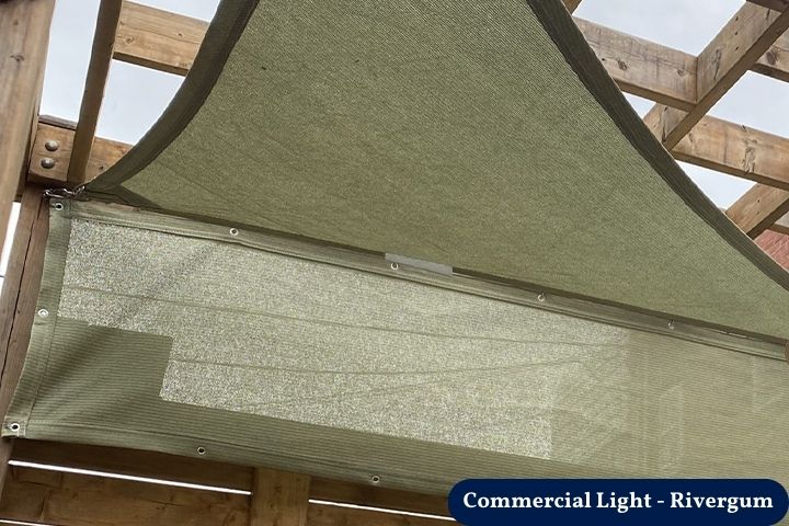 Balcony Privacy Screen installed under a wooden pergola, showing a durable mesh panel secured with grommets for added outdoor shade and privacy.