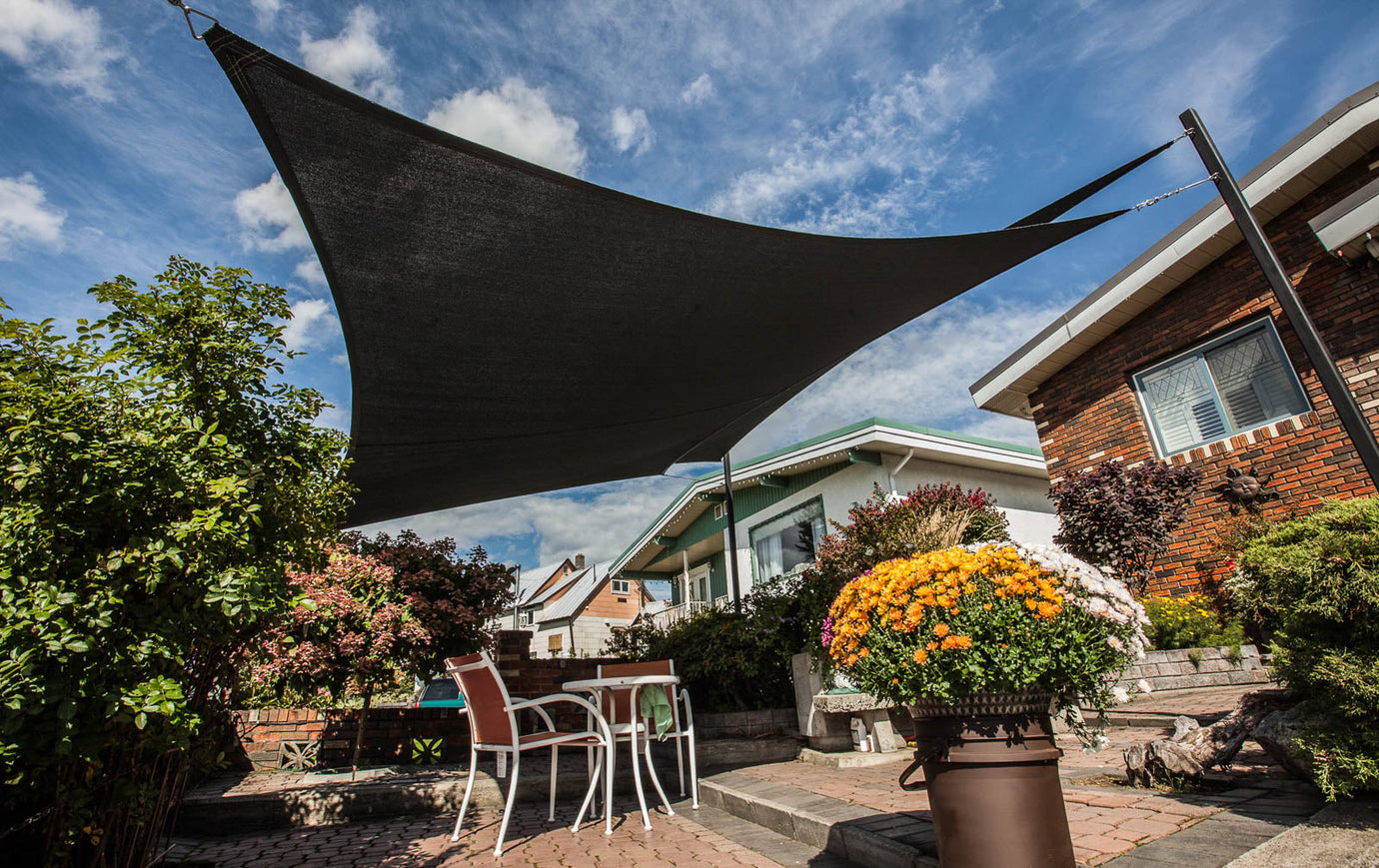 Modern backyard featuring a black triangular shade sail—illustrating high-quality products delivered efficiently for those asking, ‘When Will I Receive My Order?’