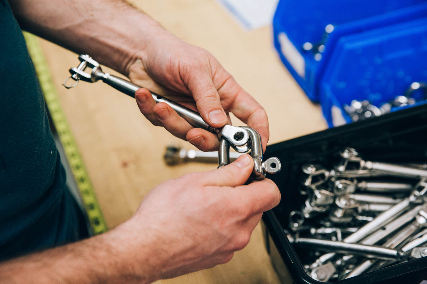 man holding parts to secure shade sails representing outdoor security