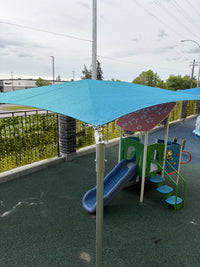 Shade sail installed over children's outdoor play area