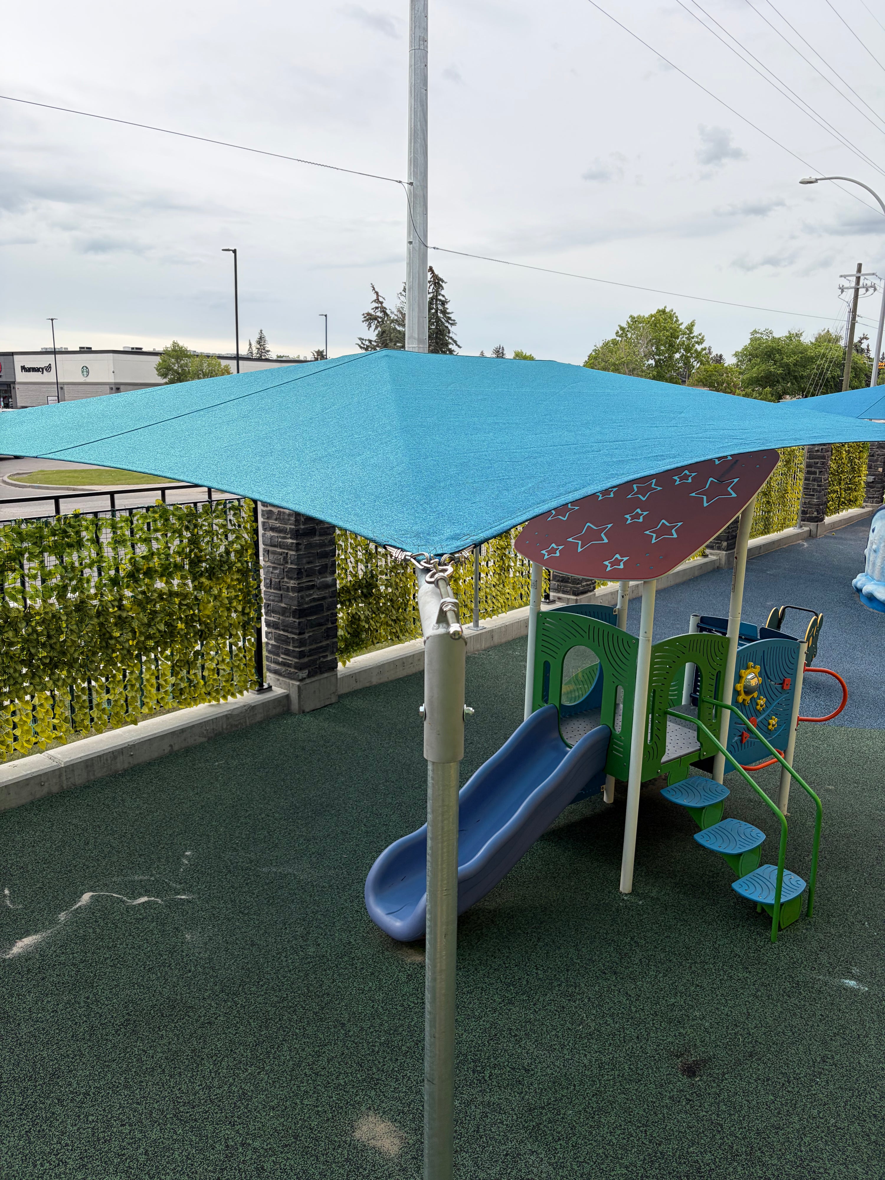 Shade sail installed over children's outdoor play area