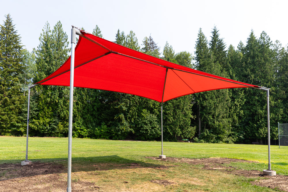 A red triangular canopy shade structure supported by four silver metal poles