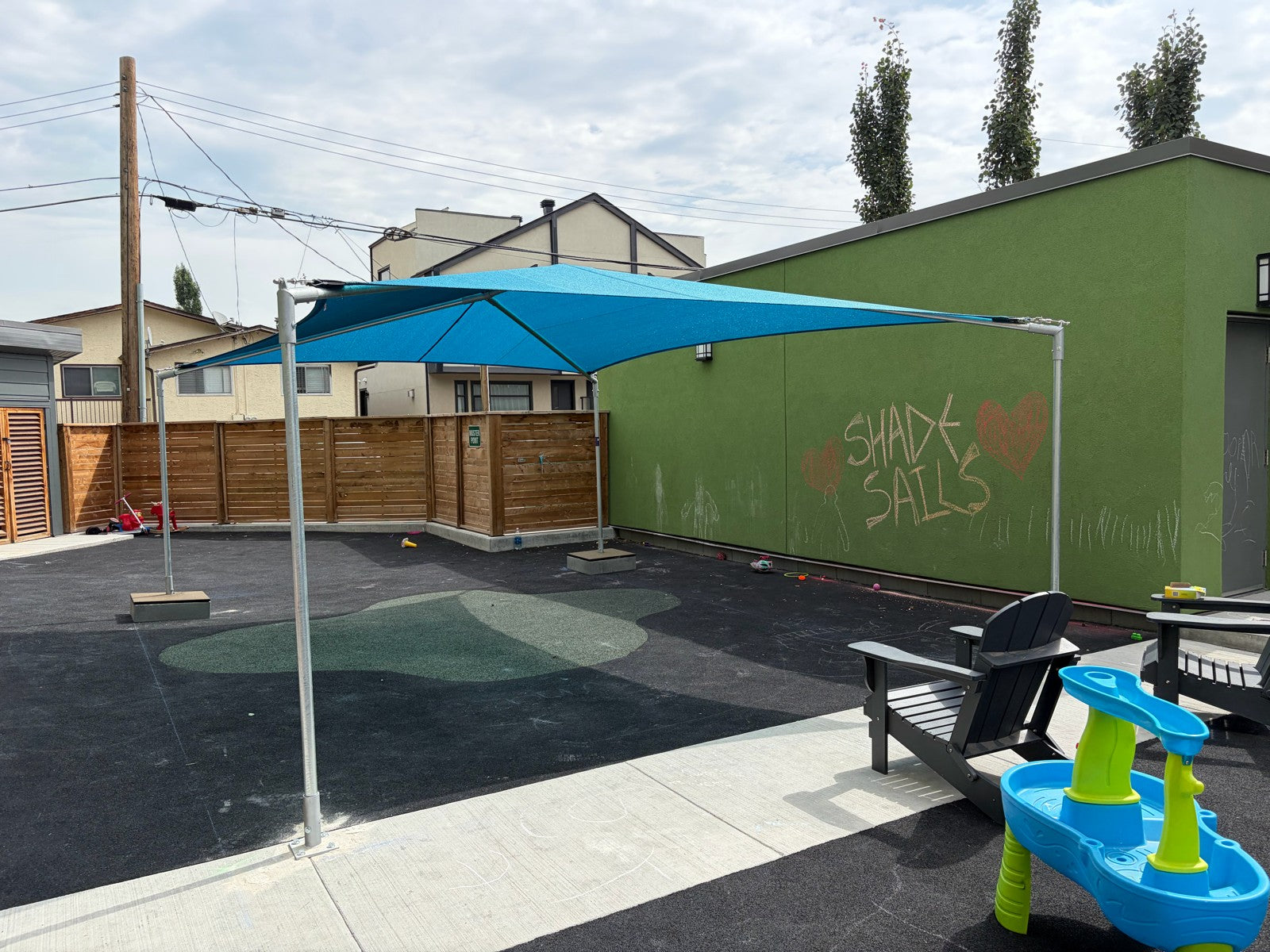 Shade sail canopy installed over park seating area