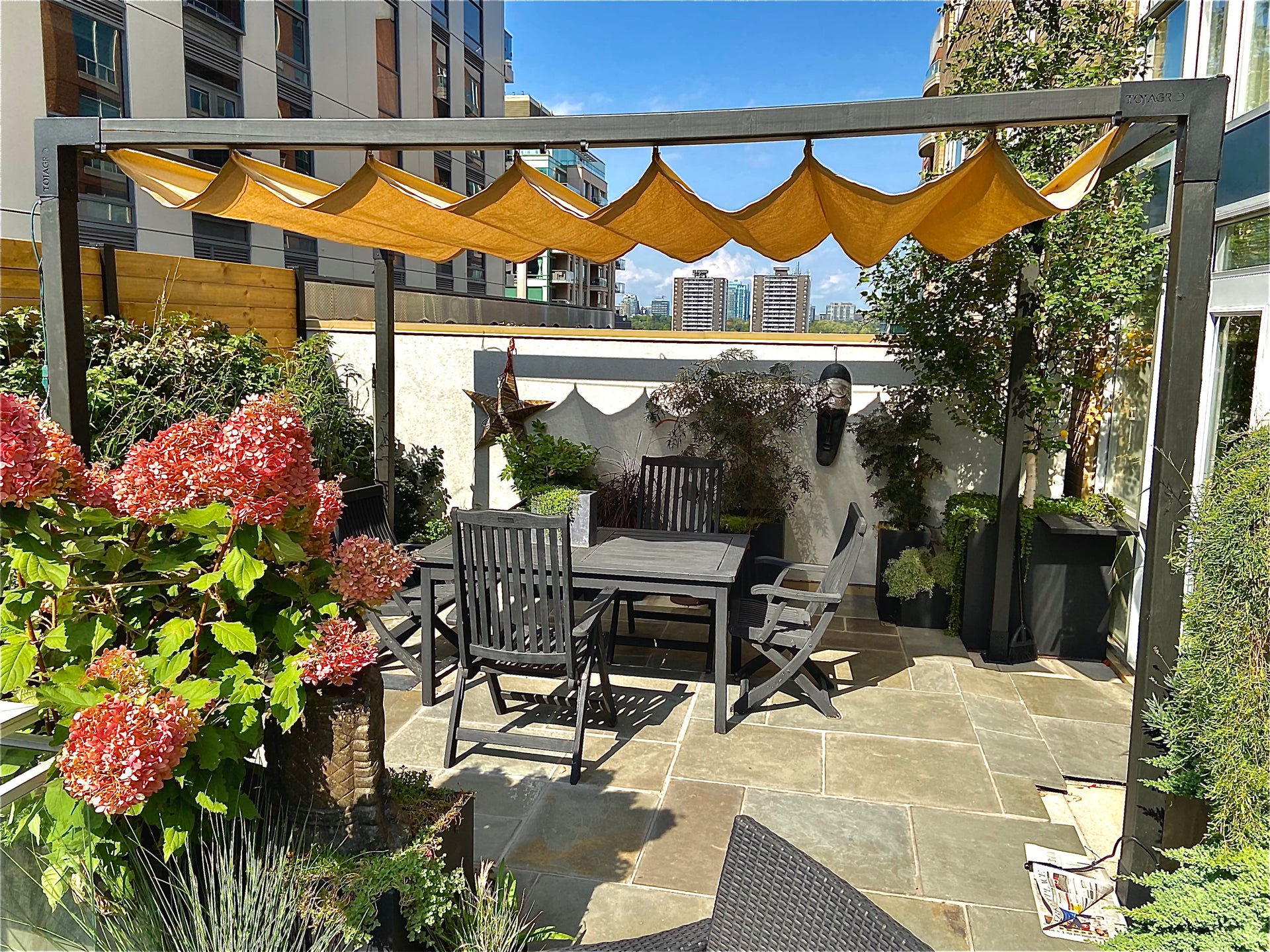backyard patio pergola with retractable roman shade sail